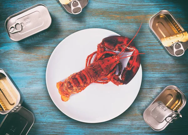 Canned lobster on wooden table — Stock Photo, Image