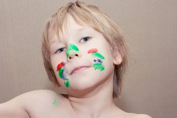 Boy with colourful painting face — Stock Photo, Image