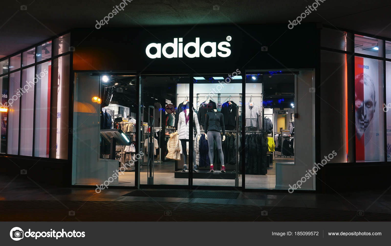 Adidas store at night in city. – Stock 