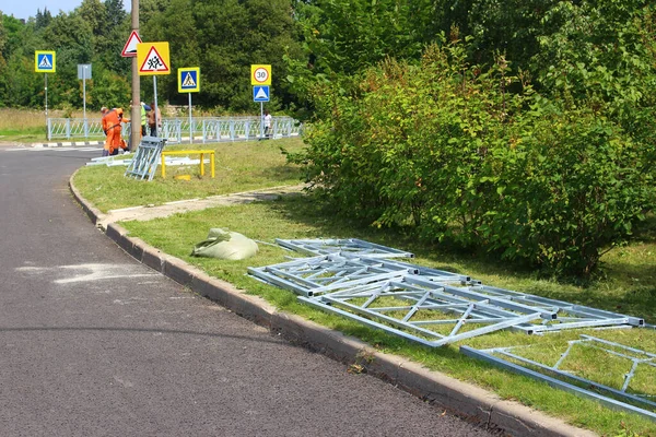 Installation of a metal fence along the road