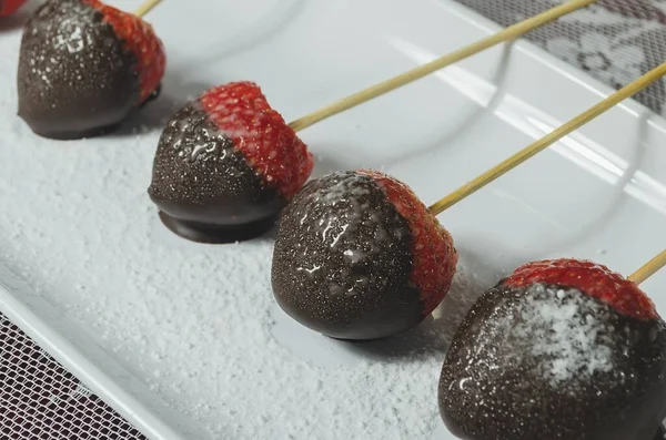 stock image valentines red strawberries in teal blue dish with melted bitter chocolate