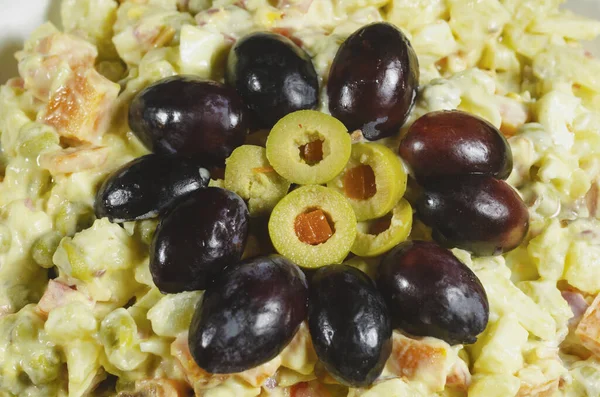 Prato de salada russo prato de Natal típico, decorado com uvas cortadas e azeitonas verdes — Fotografia de Stock