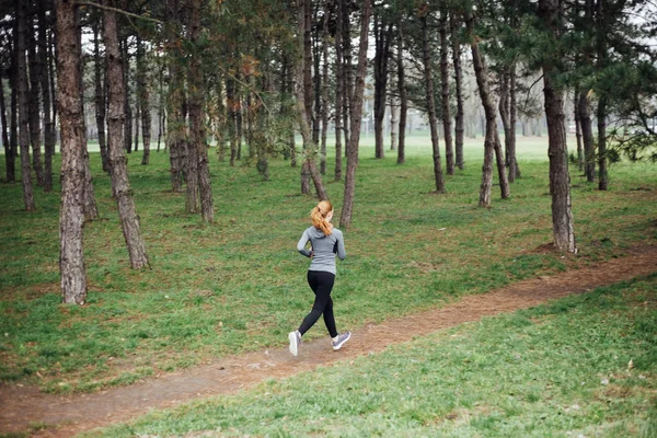 Young woman running in park