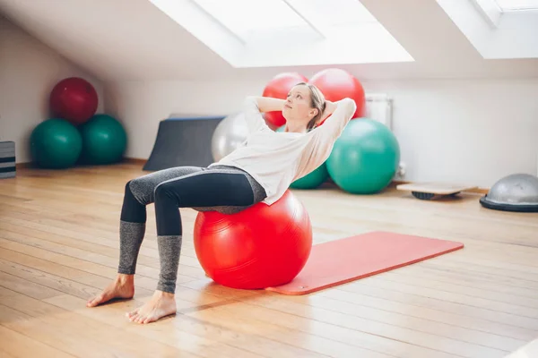 Woman doing exercises with fit ball