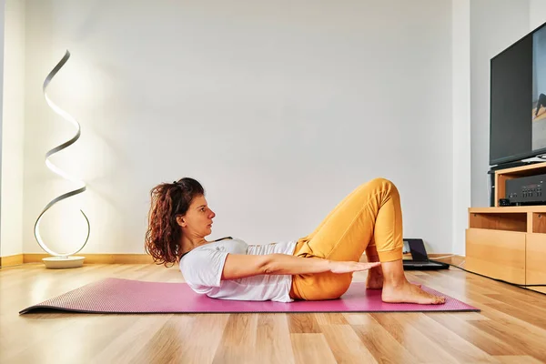 a young woman training at home during confinment by coronavirus - Training concept