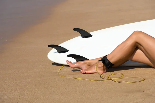 Young beautiful surfer girl on beach with surf board at day brea — Stock Photo, Image