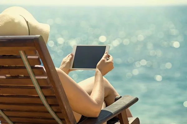 Prázdné prázdné tabletový počítač v rukou žen na pláži — Stock fotografie