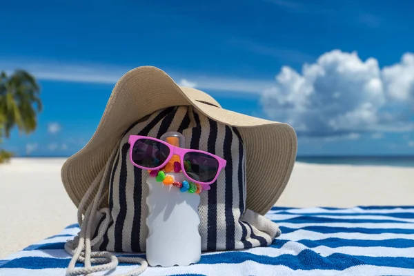 Sunscreen, hat and sunglasses on tropical beach — Stock Photo, Image