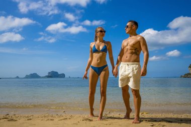 Yaz tatilinde tropik plajda genç mutlu bir çift. Tayland