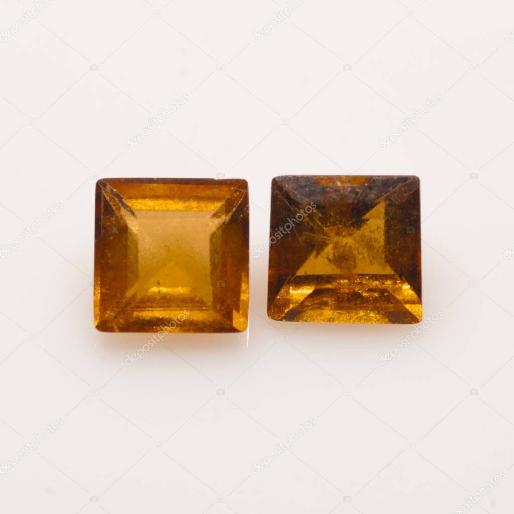 Pair of square natural orange hessonite on the white background