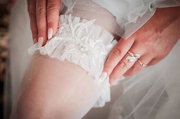 Liguero de boda blanco en la pierna de las novias — Foto de Stock