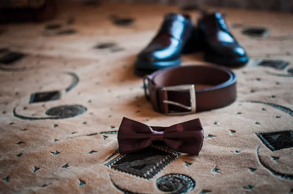 Busur sepatu Mans dan sabuk coklat di karpet — Stok Foto