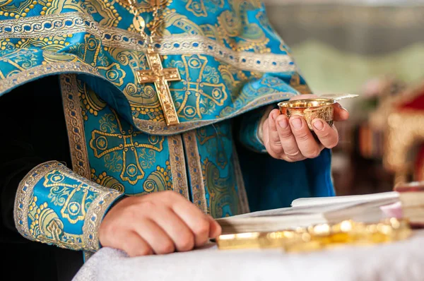 Priest holding silver chalice with wine — Stock Photo, Image