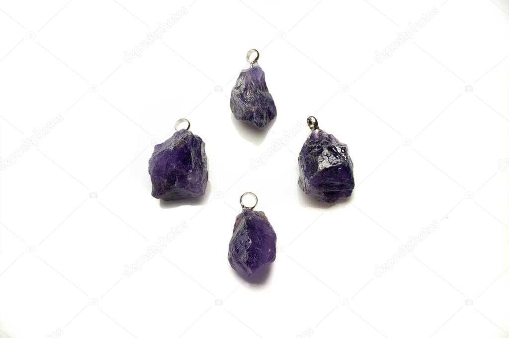 Natural violet amethyst rough pendant on the white background