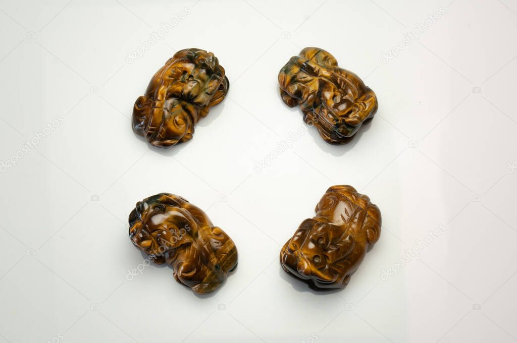 Natural tiger eye pet carving on the white background