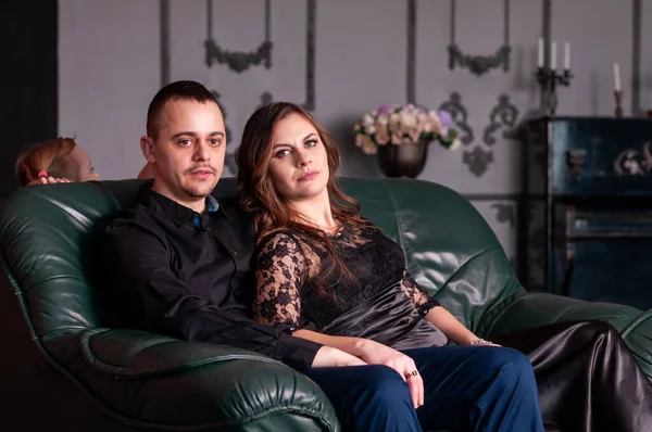 Man Hugs Woman Sitting Green Sofa — Stock Photo, Image