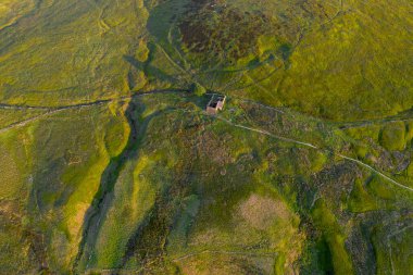 An aerial Sunrise drone shot of Top Withens or Top Withins, this farmhouse has been associated with 