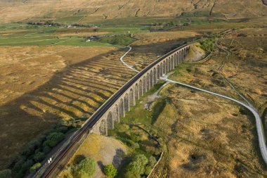 Aerial of The Ribblehead Viaduct a Grade II listed structure, the Viaduct runs the Settle to Carlisle railway route in North Yorkshire, England. clipart