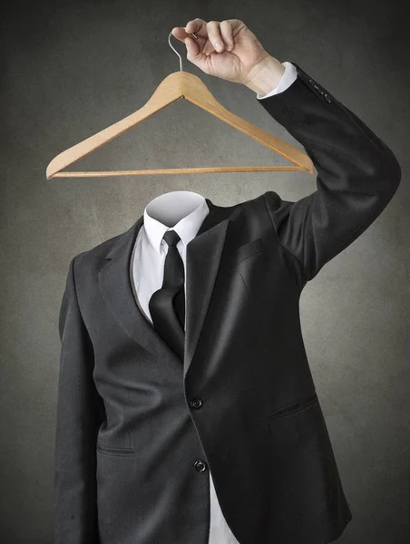 A man without a head with a clothes hanger. — Stock Photo, Image