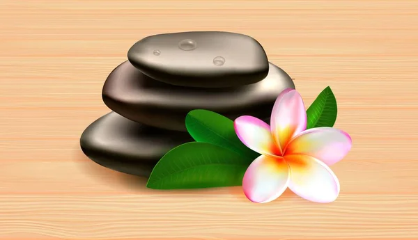 Spa stones green leaves and tropical flower on wooden table against grey background