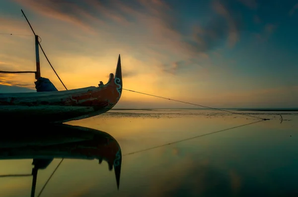 Traditional fishing vessels that still use traditional fishing gear, this boat is made of wood that is resistant to sea water. Fishing boats dock at the seashore.