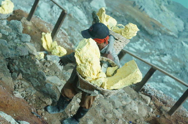 Sulfur miners ijen crater every day take a steep road with a load of 70-80 kilograms of sulfur.