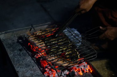 Kömürden ızgara balık yapma ve takımadalardan lezzetli ızgara balıklar üretmek için geleneksel Java baharatlarıyla özel java yemekleri yapma süreci.