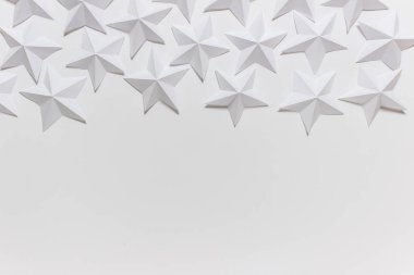 Arrangement of folded origami stars on white backgound