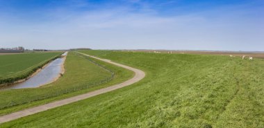 Panorama of a dike in the landscape of Groningen, Netherlands clipart