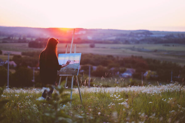 woman sitting on bench with laptop in the park