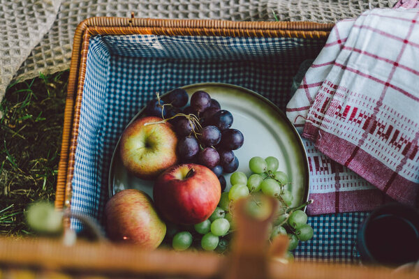 picnic basket with fruits and vegetables on the table