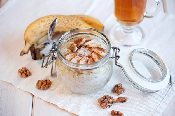 Oatmeal with banana and walnuts for breakfast — Stock Photo, Image