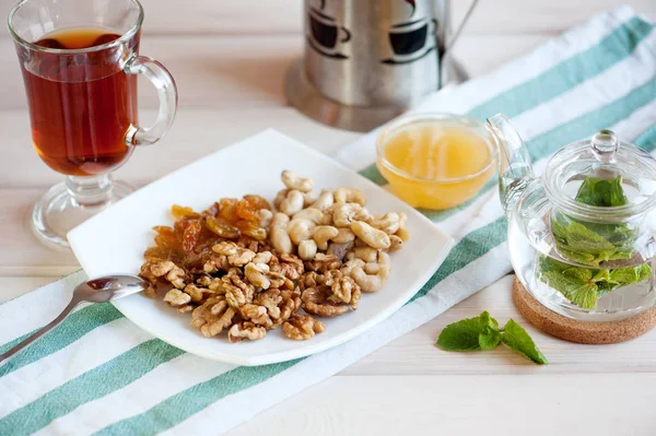 Healthy breakfast: nuts mix and mint tea — Stock Photo, Image