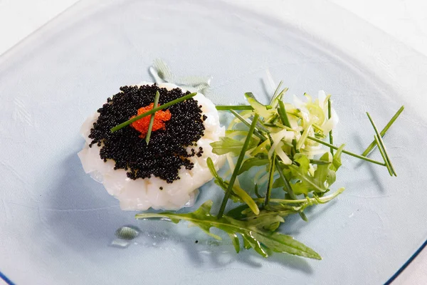 Red caviar, white caviar, fish and rucola