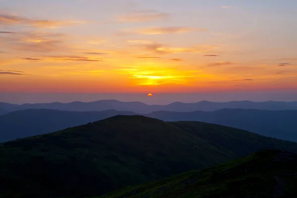 Sunrise in the mountains. The sun rises over the valleys covered with fog.