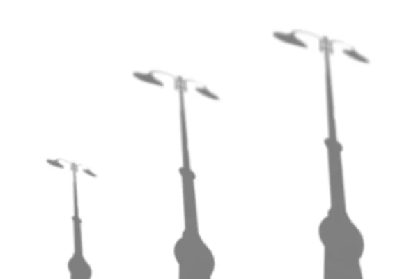 La sombra de las lámparas en una calle de la ciudad. Imagen borrosa en blanco y negro para superponer en una foto o maqueta —  Fotos de Stock