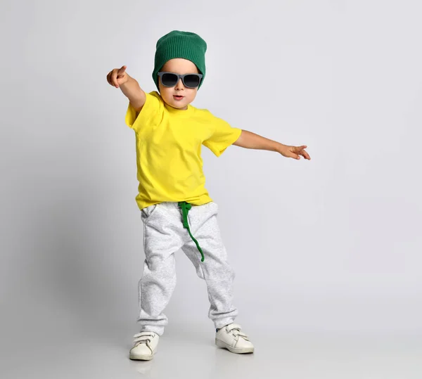 Niño apuntando con un dedo a la esquina sonriendo aislado sobre un fondo blanco —  Fotos de Stock