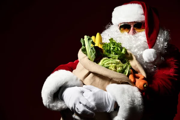 Santa Claus with a bag full of vegetables and fruits — Stock Image Santa Claus with a bag full of vegetables and fruits Royalty Free Stock Images