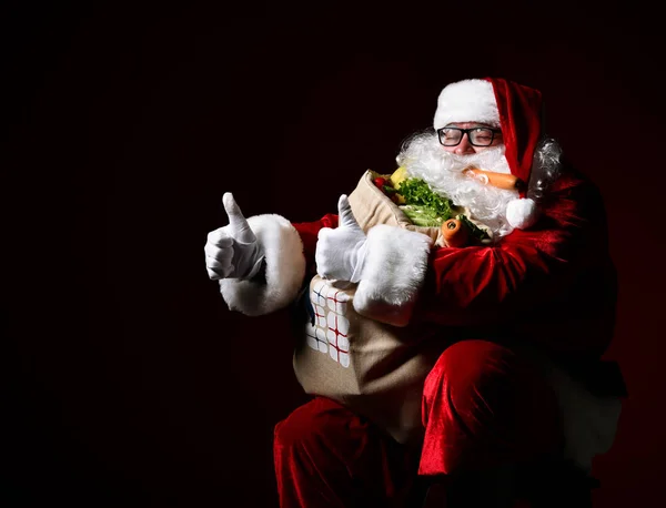 Santa Claus with a bag full of vegetables and fruits — Stock Image Santa Claus with a bag full of vegetables and fruits Royalty Free Stock Photos