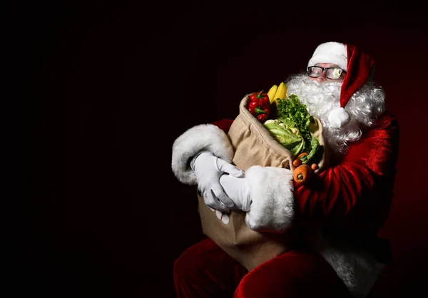 Santa Claus with a bag full of vegetables and fruits — Stock Image Santa Claus with a bag full of vegetables and fruits Royalty Free Stock Photos