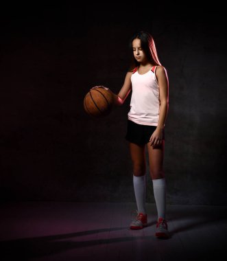 Spor giyim kuşağında basketbol oynayan güzel beyaz kadın. Spor kavramı siyah arkaplanda izole edildi.