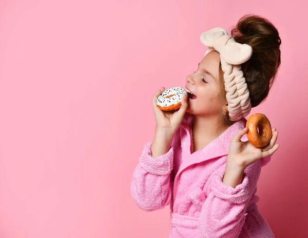 Beauty Fashion Model Girl heeft kleurrijke donuts. Grappig vrolijk meisje in Vogue stijl met snoep op een roze achtergrond. — Stockfoto