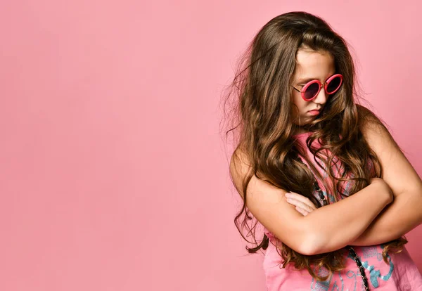 Portrait of young plus size girl with long hair in stylish summer casual clothing and sunglasses feeling displeased — ストック写真