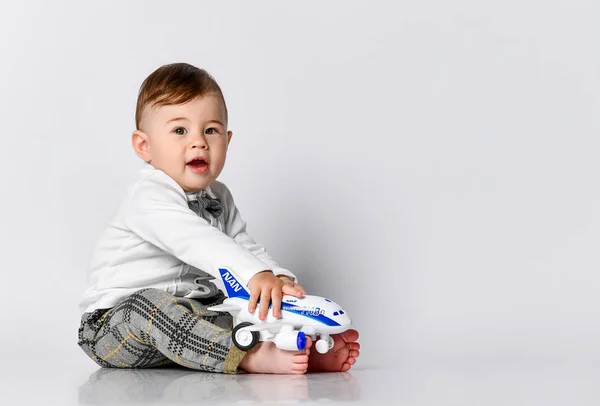 Happy child toddler playing with toy airplane and dreaming of becoming a pilot — Stock Photo, Image