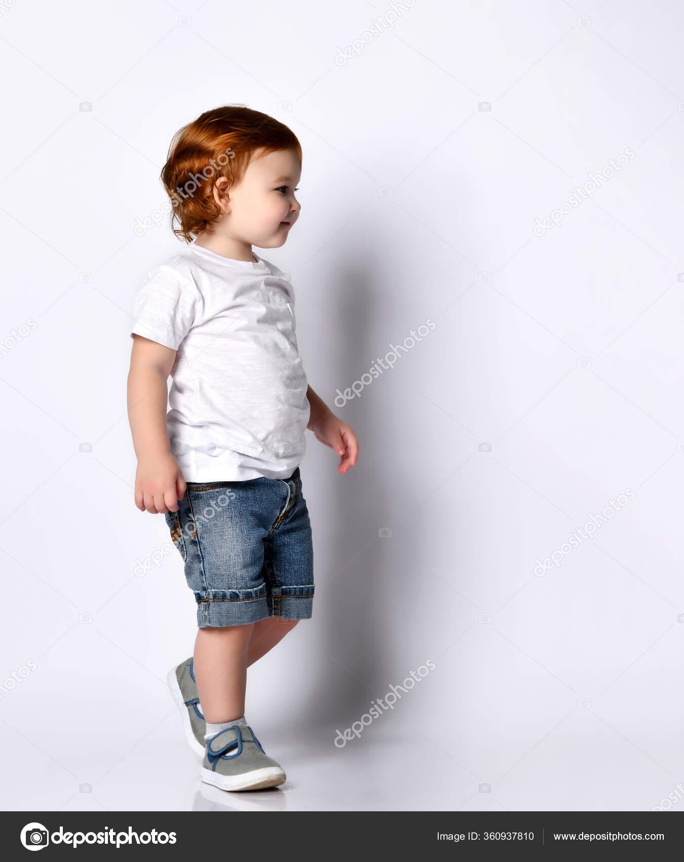 Happy little kid walking isolated over a white background