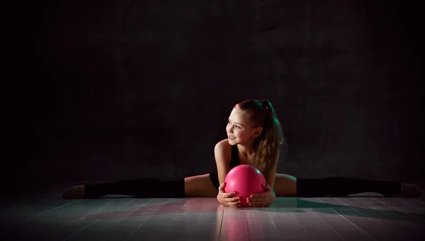 Young gymnast girl stretching and training Stock Photo