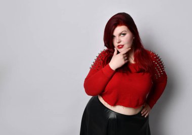 Kırmızı başlıklı şişman kızıl kadın, siyah deri etekli, küpeli. Dokunaklı yüz, elini beline koy, bembeyaz poz ver.