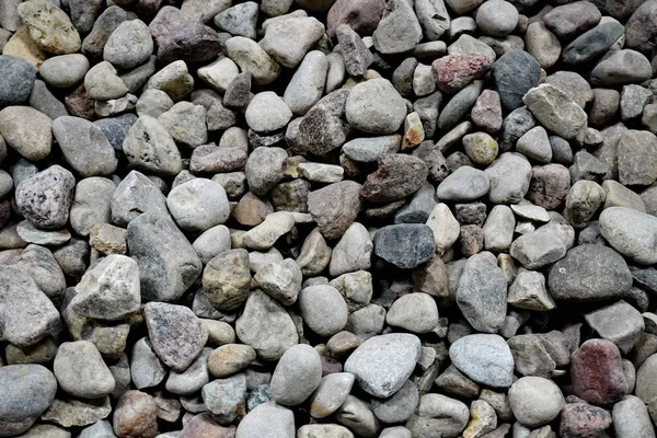 the texture of the stones for intros or background. smooth sea stones and large sharp gravel construction.