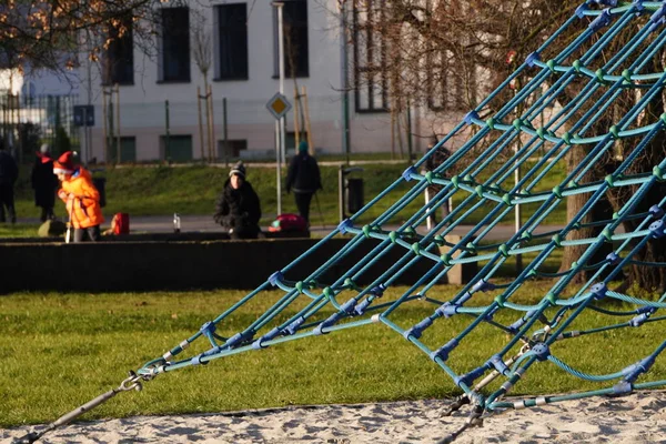 modern green children's play complex in the city Park on a Sunny day. Devices for climbing, riding on the hill.