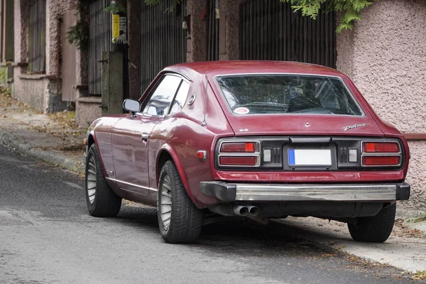 Poland, Krakow - October 4, 2019: Datsun 280Z dark cherry color, japanese oldtimer car lot in a residential area. City Parking, Parking in a closed area. Japanese car, japanese retrocar — Stock Photo, Image